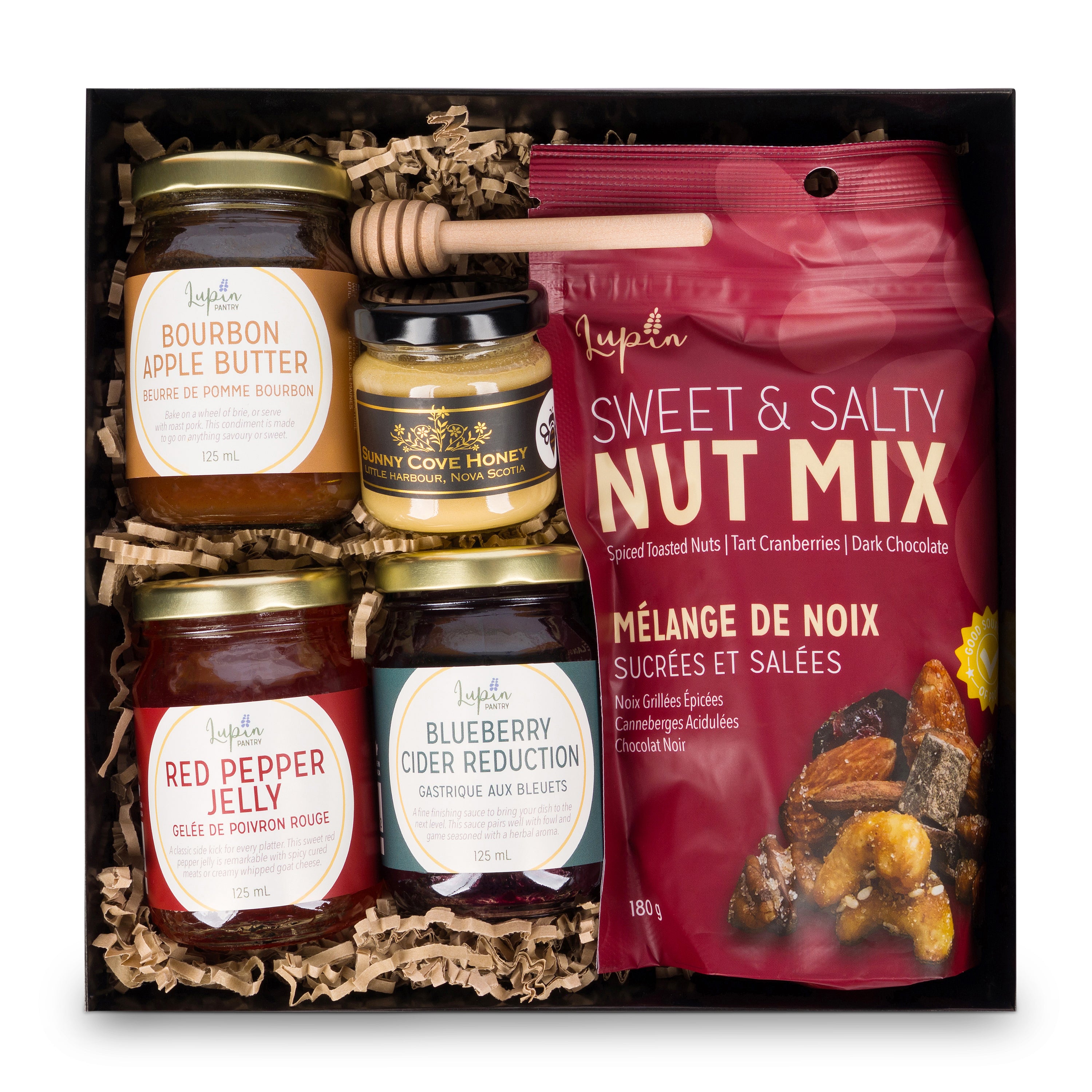 Gift set with jars of preserves and a bag of nut mix on a white background